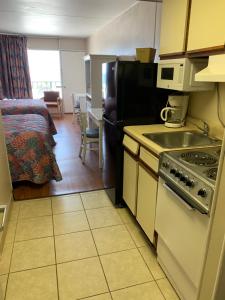 a kitchen with a sink and a stove in a room at Sea Dip Oceanfront in Myrtle Beach