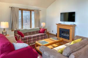 a living room with two couches and a fireplace at The Overlook in Massanuttens All Season Resort in McGaheysville