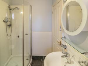 a bathroom with a sink and a shower with a mirror at Fawcet House in Whitby +23 photos