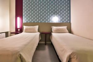 Cama ou camas em um quarto em Nobile Inn Pampulha