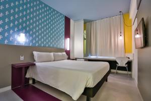 Cama ou camas em um quarto em Nobile Inn Pampulha