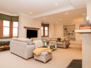 a large living room with couches and a tv at Butlers Lodge in Ashbourne