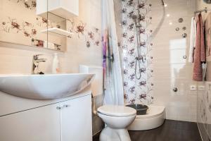 a white bathroom with a sink and a toilet at Bilić S in Dugi Rat +17 photos