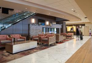 a lobby of a hotel with chairs and a bar at Horseshoe Black Hawk in Black Hawk