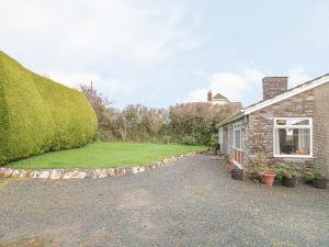 a house with a large yard next to a building at Underlanes in Camelford