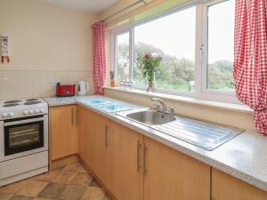 a kitchen with a sink and a window at Underlanes in Camelford