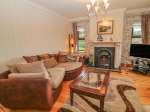 a living room with a couch and a fireplace at Starbay House in Eyeries