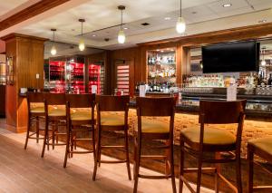 a bar with wooden chairs and a television in a restaurant at Lady Luck Casino Black Hawk in Black Hawk