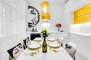 a white dining room with a white table and chairs at Drama Queen in Old Town Prague in Prague