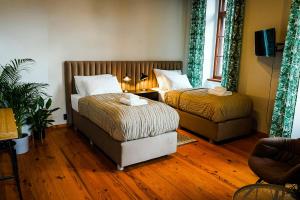 Posteľ alebo postele v izbe v ubytovaní Apartamenty w Wieży
