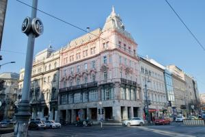 a large building on the corner of a street at Premium Apartments by Hi5 - Astoria square in Budapest