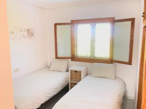 Posteľ alebo postele v izbe v ubytovaní Casa Pura Vida Guardamar del Segura