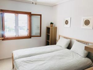 Posteľ alebo postele v izbe v ubytovaní Casa Pura Vida Guardamar del Segura
