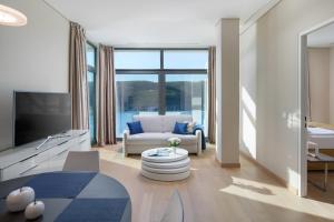 ein Wohnzimmer mit einem Sofa und einem TV in der Unterkunft Luxury Apartment Istra Rabac - Penthouse RAB in Rabac