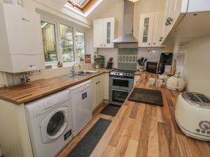 a kitchen with a washer and dryer in it at Manod View in Blaenau-Ffestiniog