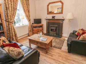 a living room with a couch and a fireplace at Manod View in Blaenau-Ffestiniog