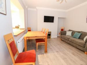 a living room with a table and a couch at Lincoln House in Lincoln