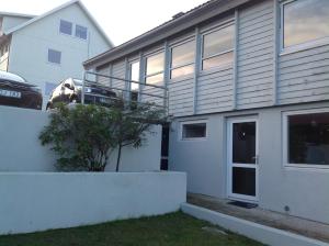 a house with a car parked in front of it at Marna Luxus Guesthouse doubleroom nr.3 in Tórshavn