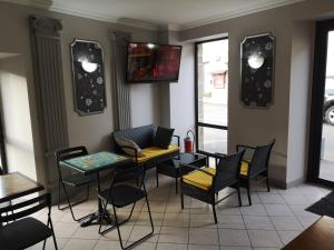 een eetkamer met stoelen en een tafel en een tafel met een stoel bij Hotel du Languedoc in Langogne