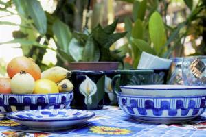 a table with blue and white plates and bowls of fruit at Casa Santaella in Puerto Escondido