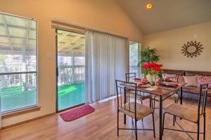 a dining room with a table and chairs and a couch at Houston Apt with Private Balcony 14 Mi to Downtown! in Houston