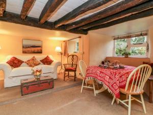 a living room with a bed and a table at Whitefield Cottage in Barnstaple