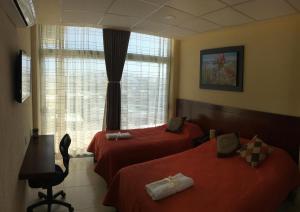 Un pat sau paturi într-o cameră la Harbour Inn - Veracruz