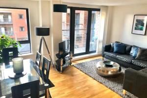 a living room with a couch and a table at Duke Street - Liverpool city centre apartment in Liverpool