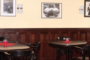 two tables in a restaurant with a train on the wall at Hotel in in Amberg