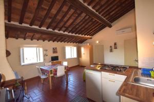 a kitchen with a table and a counter top at LA TORRETTA in Campiglia Marittima