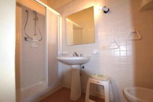 a bathroom with a sink and a shower with a mirror at LA TORRETTA in Campiglia Marittima