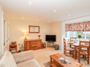 a living room with a couch and a table at Mayflower in Swanage