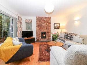 a living room with a couch and a fireplace at Casalmare in Exmouth