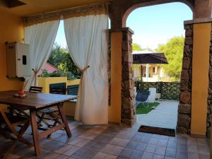 a dining room with a table and a patio at Villa Panamàr in San Teodoro
