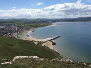 an aerial view of a beach and the ocean at Beside The Sea - In Town in Llandudno