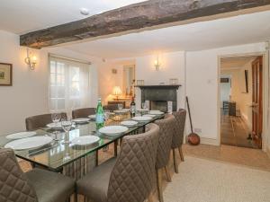 a dining room with a table and chairs and a fireplace at Dolphin House in Burford