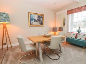 a dining room with a table and chairs at South Tower Cottage in Macclesfield