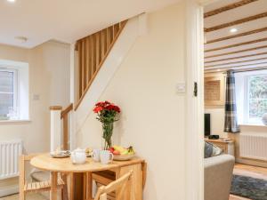 ein Wohnzimmer mit Tisch und Treppe in der Unterkunft Tilly's Cottage in Westbury + 19 Fotos