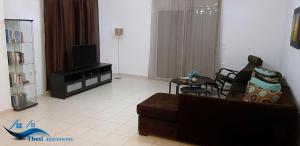 Televízia a/alebo spoločenská miestnosť v ubytovaní Theti Apartment