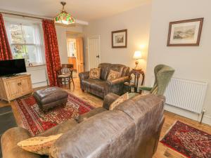 a living room with a couch and chairs and a tv at Sygun View in Caernarfon