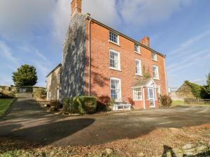 an old red brick building with a large window at Squires Rest in Welshpool