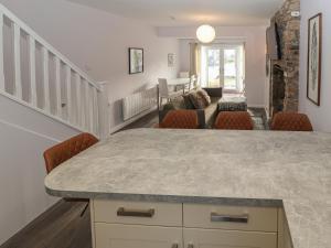 a kitchen and living room with a large counter top at Ty Bach, Great Orme in Llandudno +20 photos