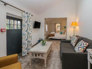 a living room with a couch and a coffee table at Lakeside Cottage in Macclesfield