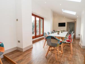 a dining room with a table and chairs at Lakeside Village & The Potting Shed in Macclesfield