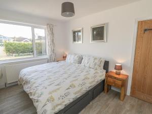 a bedroom with a large bed and a window at The Bungalow at Mill Falls in Great Driffield