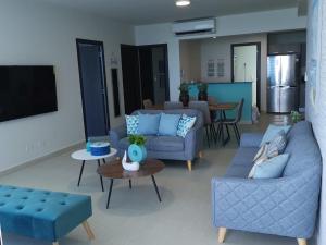 a living room with two couches and a tv at Ocean 3, Playa Blanca in Río Hato