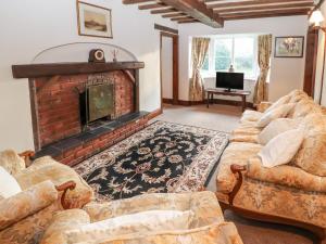 a living room with couches and a fireplace at Milton Green Farm in Chester