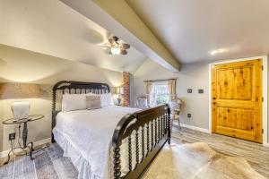 a bedroom with a bed and a wooden door at The Cabin @ Durst Haus in Fredericksburg