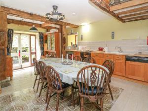 a kitchen with a dining room table and chairs at Felin Iago in Aberystwyth