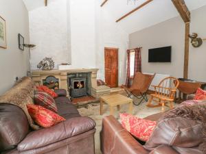 a living room with a couch and a fireplace at Felin Iago in Aberystwyth